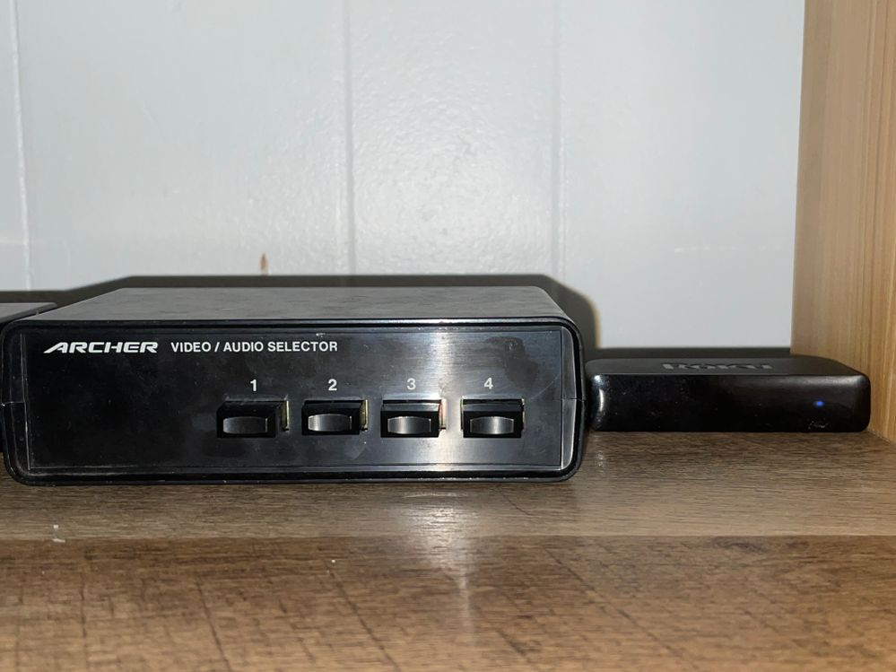 Front view of the Roku and the switcher used; an Archer/Radio Shack 15-1956 4-input switcher (ver. B/Made in China, mfd. April 1993).  As you can tell, the Roku device is much smaller and 25 years newer than the switcher.