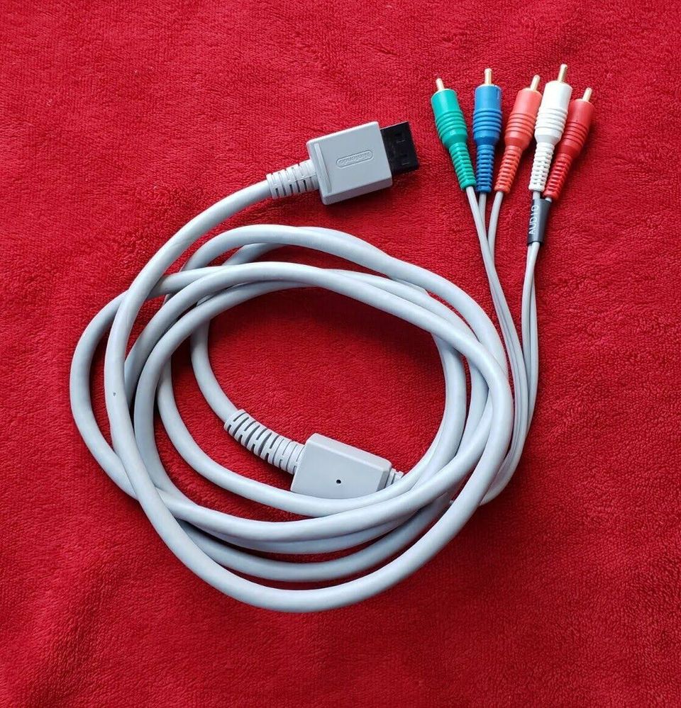 The Wii-U also supports these cables (which output up to 1080i).  They are called Component cables.  The green cable is labeled Y, the blue cable is labeled Pb/Cb, and the red (video) is labeled Pr/Cr.  Model number of these is RVL-011. (Photo credit: chrislexgames2020 on eBay)  These cables, however, will only output 720p and 1080i in Wii U mode.  Wii Mode on this console will only output up to 480p, ‘cause that is how the original Wii consoles looked.